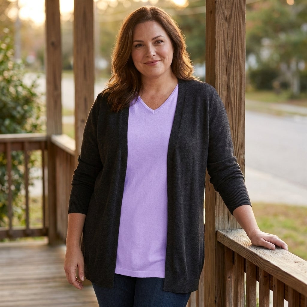 Close view of a knit tunic layered under an open cardigan in warm evening light